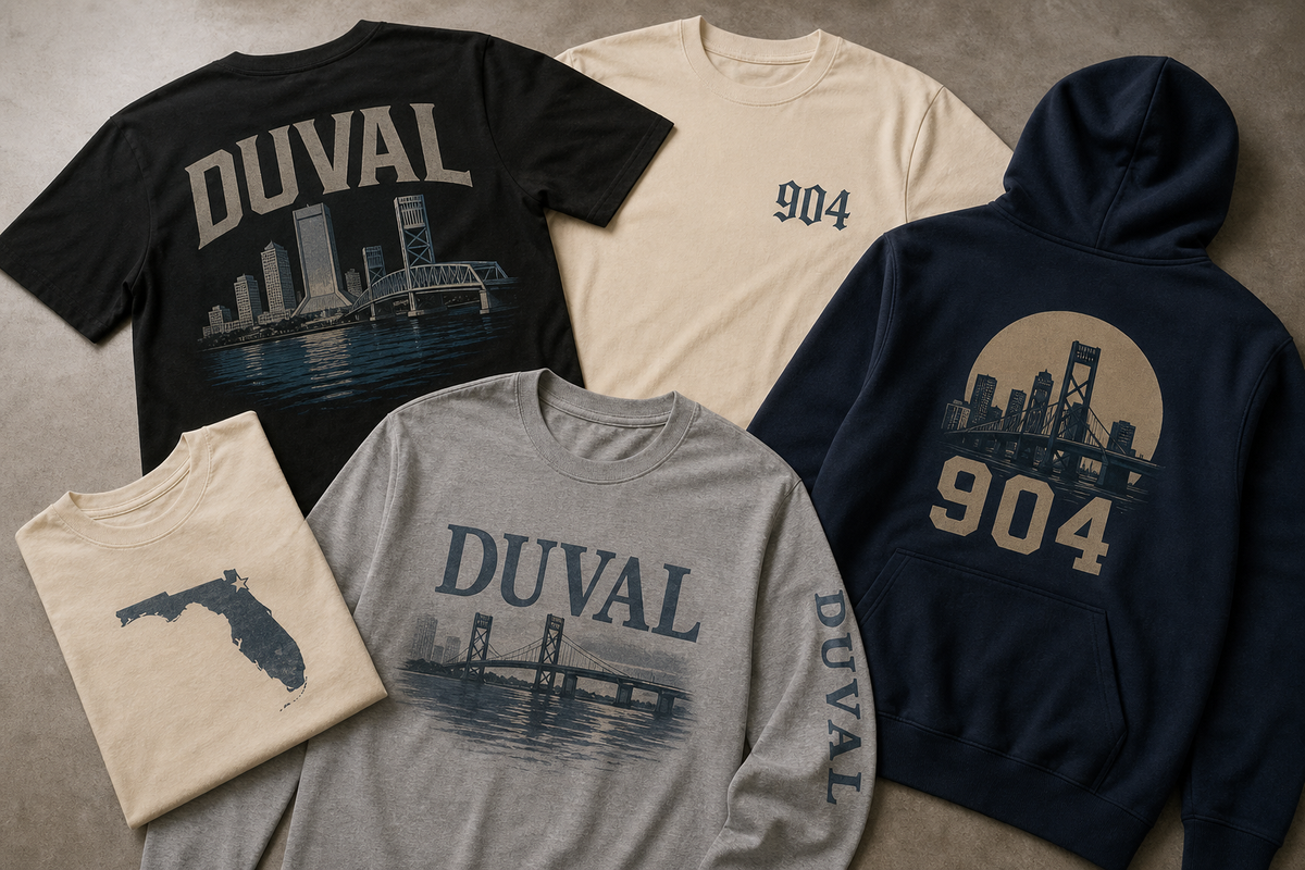 Jacksonville local pride apparel including graphic tees, a long sleeve shirt, and a hoodie arranged in a flat lay.